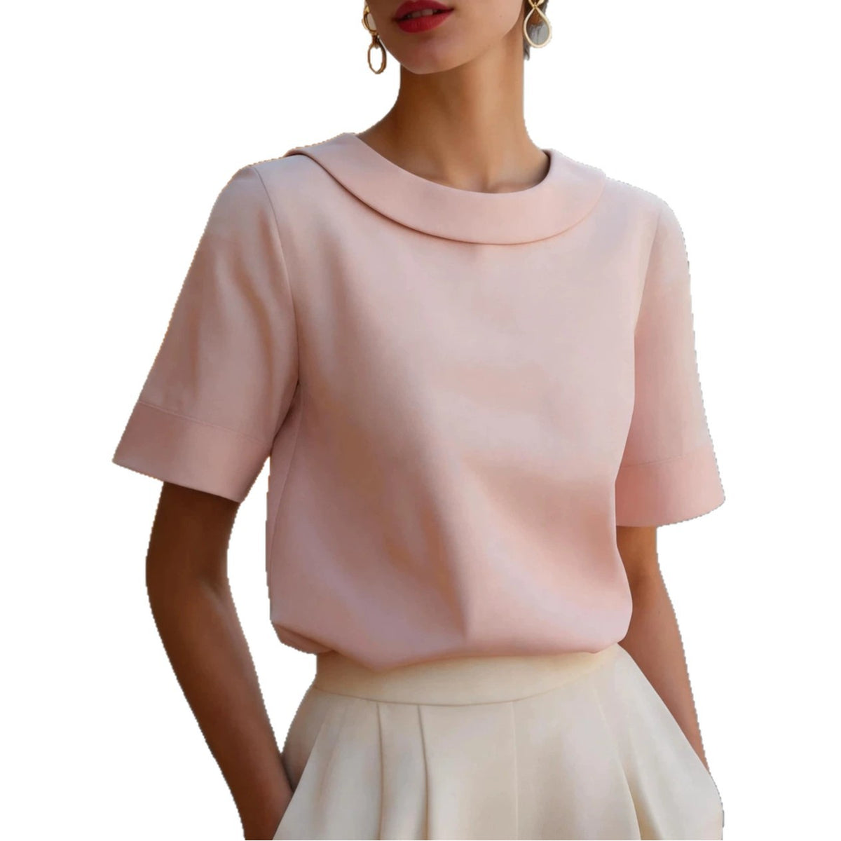 Woman wearing a light pink short sleeve blouse with a rounded collar and cream skirt.